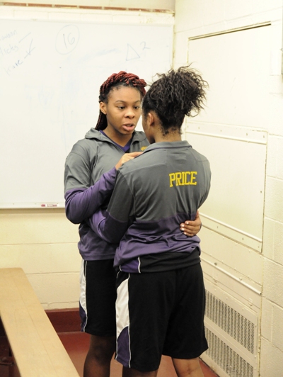 Senior Air'shay Lampkin (left) consoles freshman Nija Price in the locker room after the game.