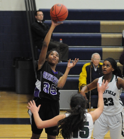 Nija Price scores over Whitfield's Kelsey Chadwick (left) and Taylor Lawson-Hicks.