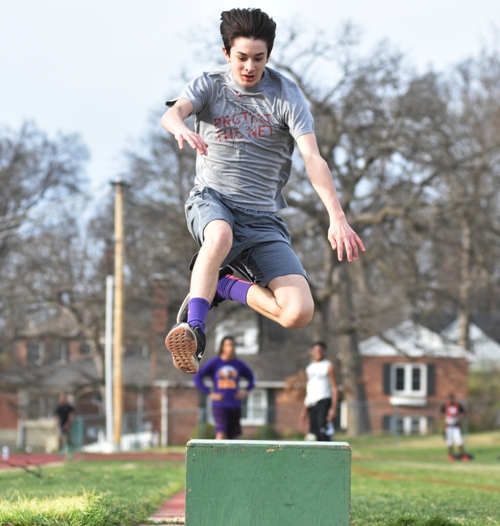 Freshman Billy Flynn practices the long jump.